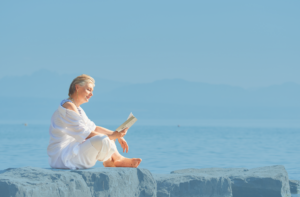 lady reading at seaside