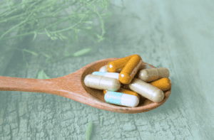 Pills on a wooden spoon