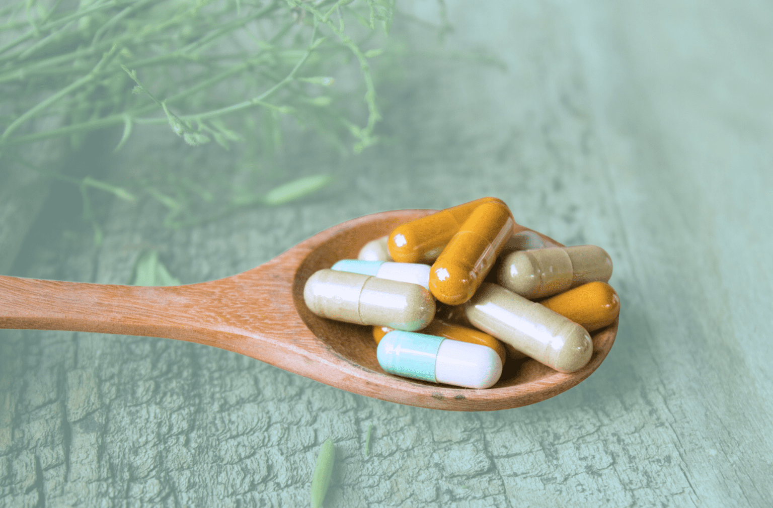 Pills on a wooden spoon